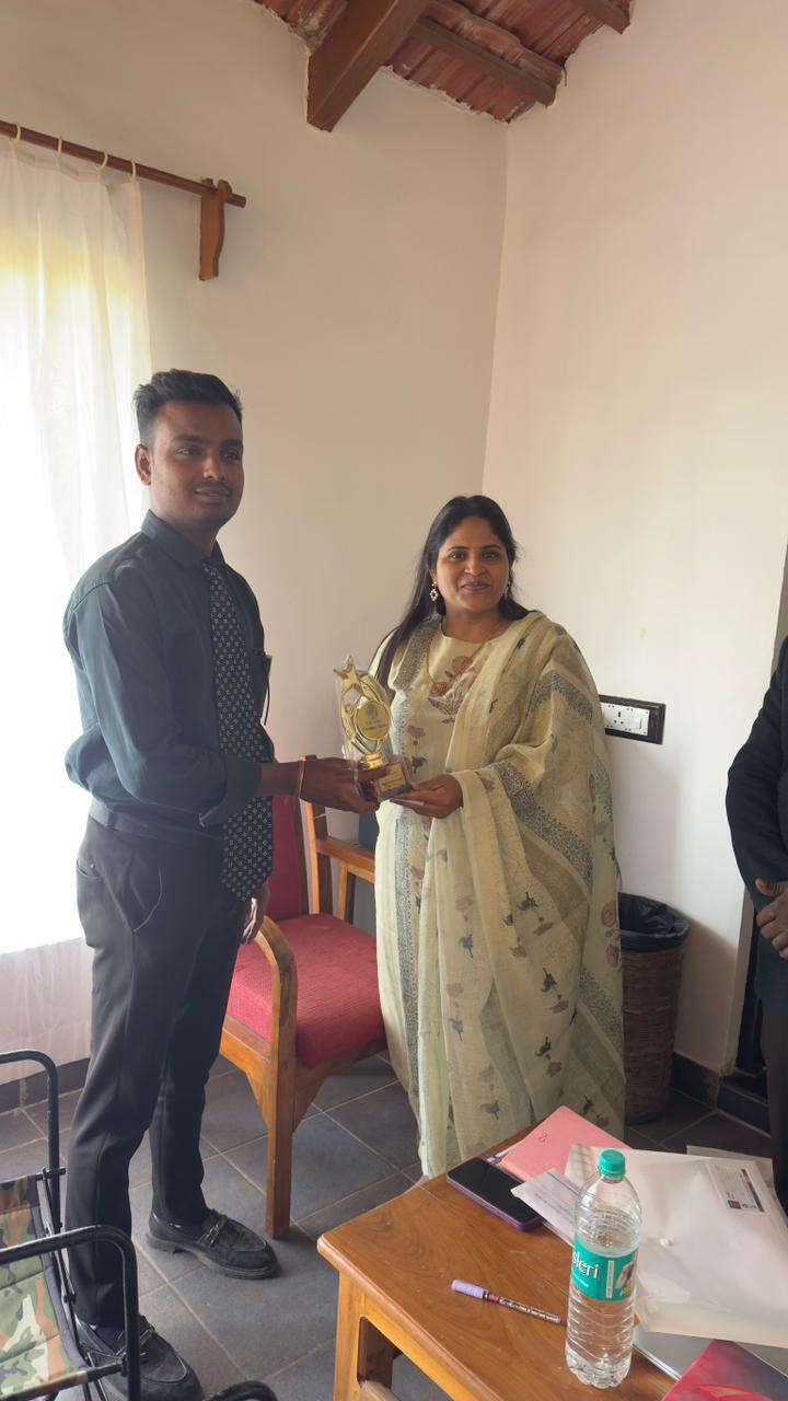 Universe Formulations team member receiving a trophy from the founder